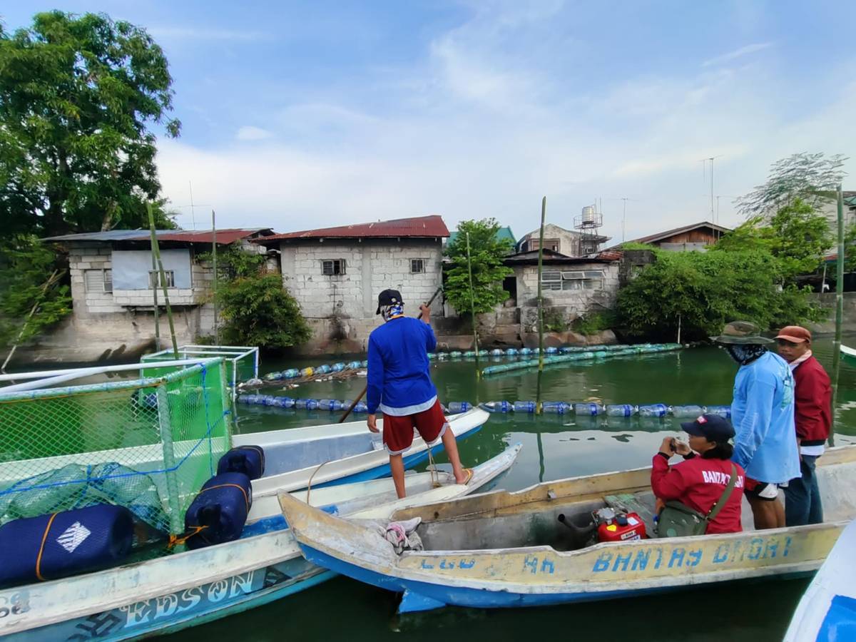 FISHERMEN place booms and trash traps on a river in Sitio Pulo, Barangay Kabalutan, Orani, Bataan on 28 June as part of the Orani Mangrove Adoption and Protection Project of the local government and GNPower Mariveles Energy Center Ltd. Co.